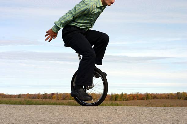 бизнес моноцикл баланс - unicycle стоковые фото и изображения