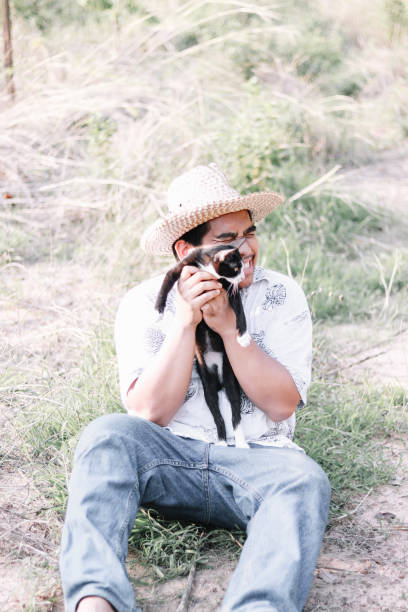 istock farmer play with his cat 1150654681
