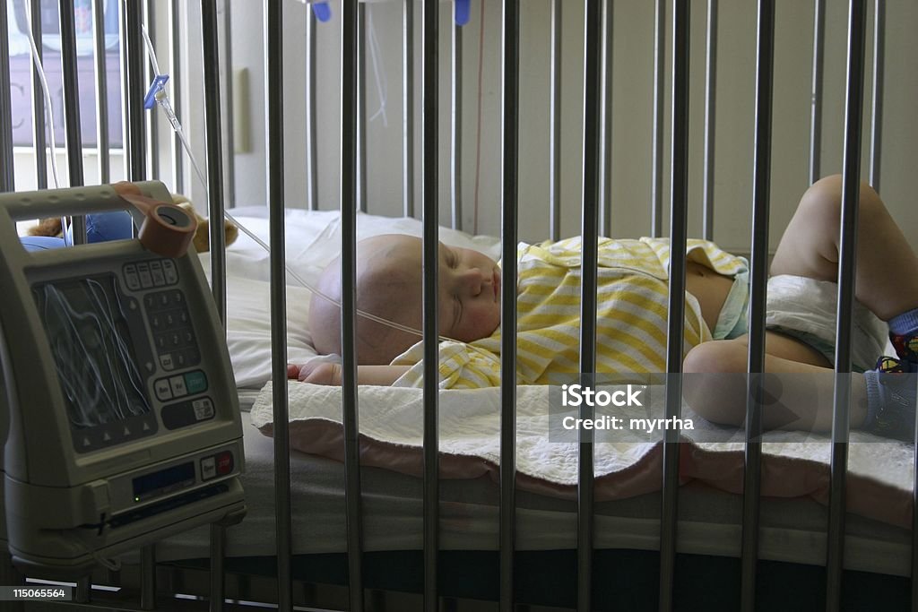 Cancer Kids; baby receiving chemotherapy sleeping toddler in hospital crib enduring yet another round of treatment Baby - Human Age Stock Photo