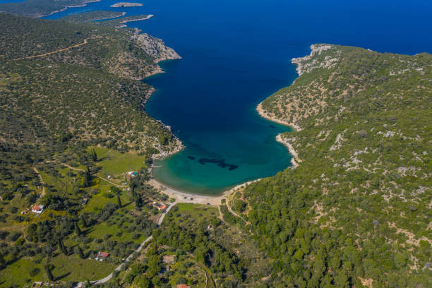 Top view Greek island Poros beache. Vagionia bay. Paralia Vagonia. Blue water and hills. Epic panoramic view. Travel destination. greece islands beaches. Aerial view from the drone Top view Greek island Poros beache. Vagionia bay. Paralia Vagonia. Blue water and hills. Epic panoramic view. Popular touristic destination. Greece islands beaches. Aerial view from the drone paralia stock pictures, royalty-free photos & images