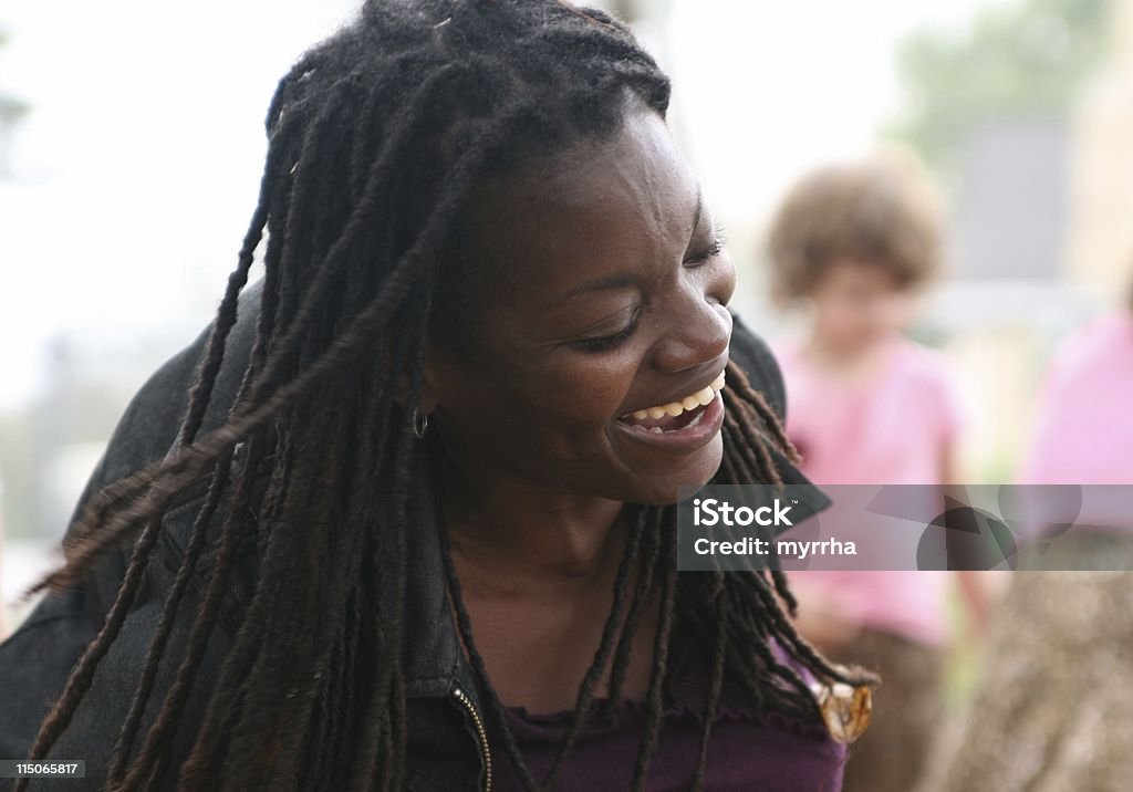 Laughing Woman black lady playing in autumn leaves Adult Stock Photo