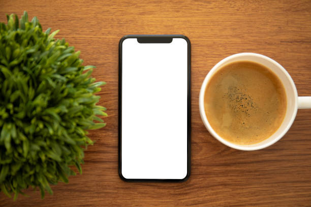 istock phone with Isolated screen on a yellow office table 1150658464