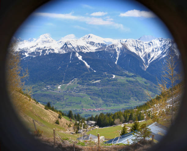 istock view on alpine snowy peak mountains  from binoculars 1150659044