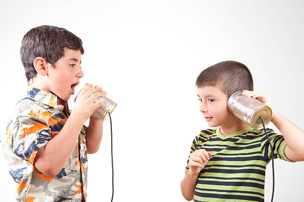 istock Two Little Boys Communicating And Talking On Tin Can Phone 115065952