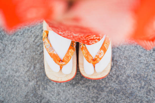 Girl's legs wearing Kimono and Japanese sandals Legs of Japanese girl wearing Kimono. geta sandal photos stock pictures, royalty-free photos & images