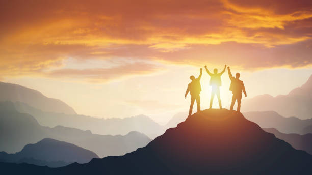 istock Group of peoples on mountains top in winner pose 1150660604