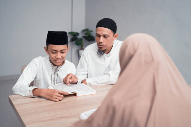 istock muslim father teaching his son how to read quran 1150660627