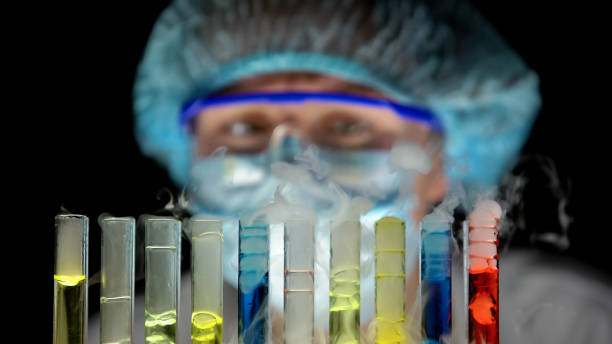 istock Scientist checking reaction in test tubes with multicolor liquids, poisons 1150660642