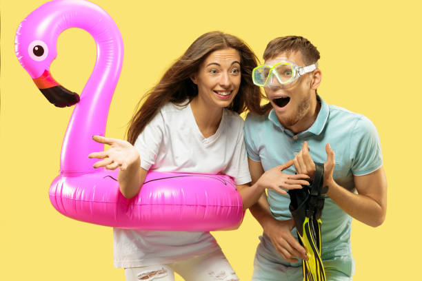 istock Beautiful couple isolated on yellow studio background 1150660650