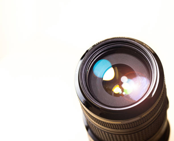 istock lens digital camera, selective focus, close-up, side with reflection, bokeh, isolated on white background 1150660982