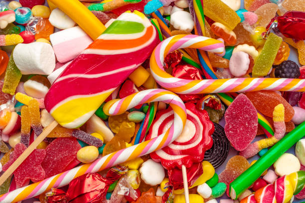 istock Colorful candies on table on blue background 1150661021