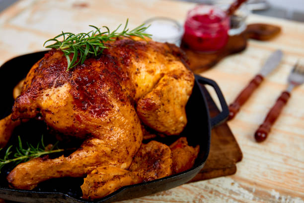 istock Baked whole chicken with apples in pan 1150661048