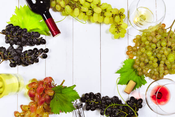 istock wine with branches of white grapes. On a wooden table. 1150661220