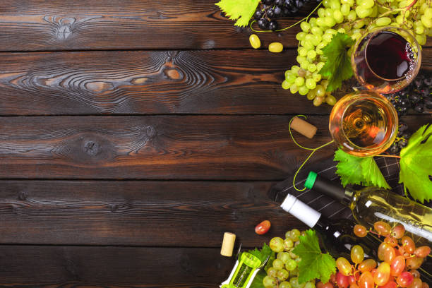 istock wine with branches of white grapes. On a wooden table. 1150661311