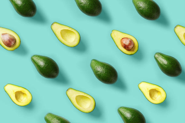 istock Avocado pattern on blue background. Pop art design, creative summer food concept. Green avocadoes, minimal flat lay style. Top view. 1150661483
