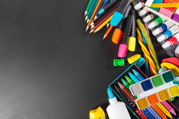 istock School supplies bottom border on a chalkboard background 1150663366