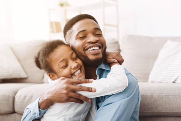 istock Adorable daughter hugging father with love and tenderness 1150663384