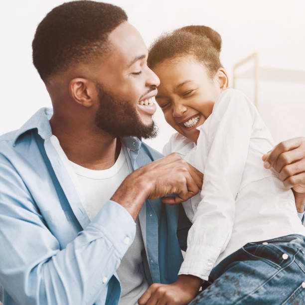 istock Father tickling daughter, playing together at home 1150663397
