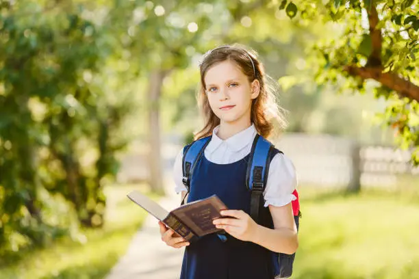 Photo of ten-year-old schoolgirl with a book