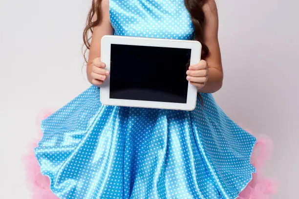 Modern technologies. Computer tablet. Blue dress.