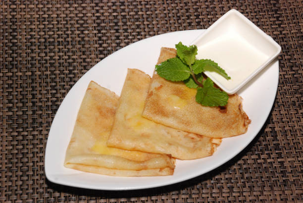 istock russian pancakes with sour cream on the white plate 1150665672