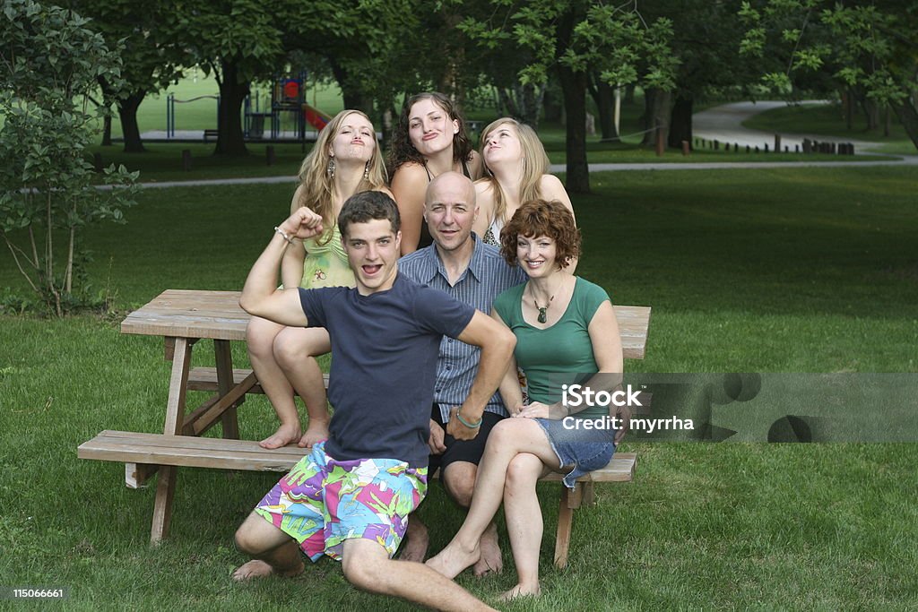 Family Fun; there's one in every crowd teenaged boy clowning around for the camera while his sisters act silly, too. Blond Hair Stock Photo