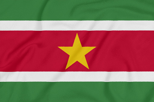 Flag of Suriname on textured fabric. Patriotic symbol