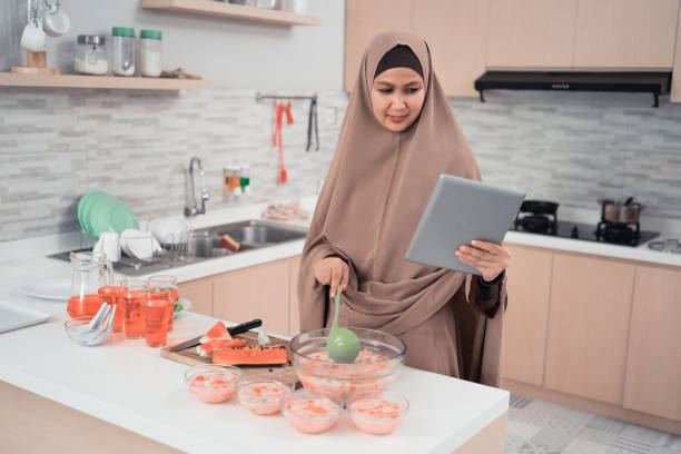 istock woman holding tablet looking for recipe on internet while cooking 1150669586