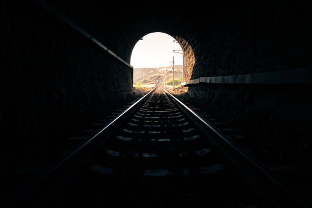 licht am ende des tunnels - train tunnel stock-fotos und bilder