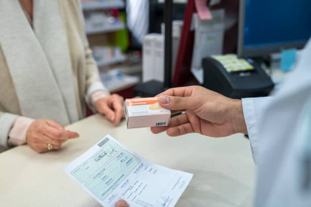 istock Pharmacist giving medicine box to customer 1150671527