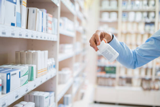 istock Man's hand holding pill bottle 1150671551