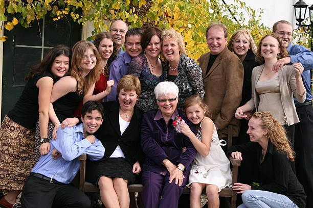 Extended Family Group Fun Grandma's 80th birthday party enjoys a big hug happy birthday cousin stock pictures, royalty-free photos & images