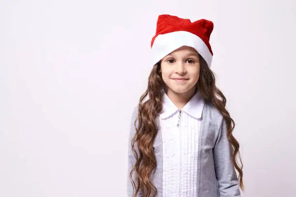 Pretty Girl. Christmas hat. White background.