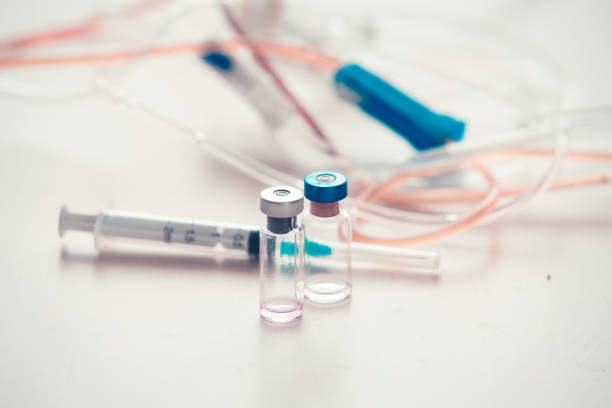 istock Medical background with  syringe and vaccine bottles 1150674812