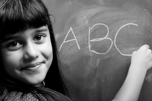 Black And White Portrait Of Little Girl Learning Alphabet
