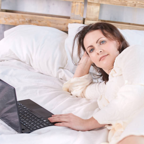 istock Beautiful girl. Work at home. White background. Black notebook 1150676018