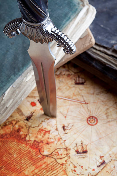 istock Full Frame Antique Books And Dagger On Map Background 115067612