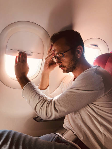 istock Tired / sick passenger in a modern airplane seat next to the window. 1150679299