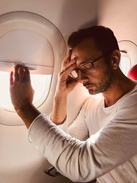 istock Tired / sick passenger in a modern airplane seat next to the window. 1150679348