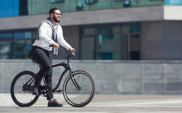 istock Handsome young businessman riding on his bicycle 1150685631