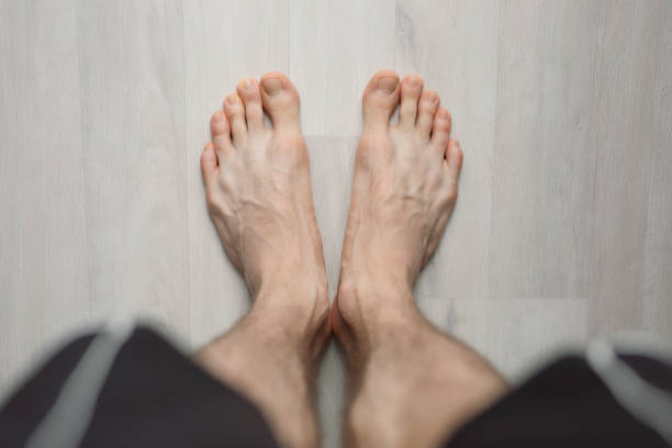 POV, man barefoot on the floor, male legs