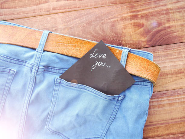 Blue jeans peek out of a paper bag. Isolated on a white background. The concept of eco-friendly shopping