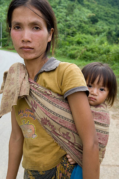 Portrait Hmong woman with baby Portrait Hmong woman with baby, at a street in the District Khanthao miao minority stock pictures, royalty-free photos & images