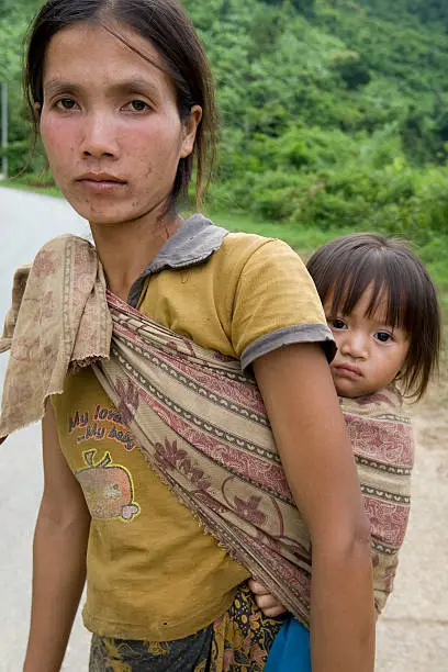 Portrait Hmong woman with baby, at a street in the District Khanthao