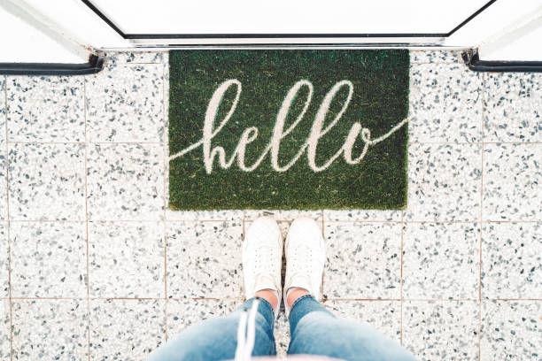 istock Welcoming green doormat that says Hello 1150688398