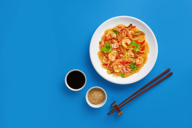 istock Fried noodles - asian food on blue background 1150693322