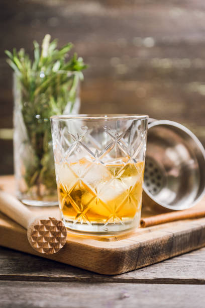 istock Old fahioned cocktail on the rustic background 1150694393