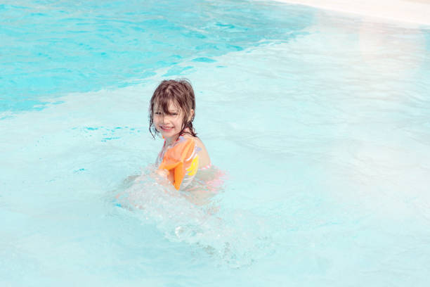 istock beautiful child playing in the pool in summer 1150694619