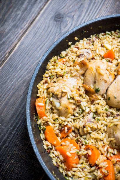 istock Fried rice with vegetables and chicken in pan 1150695021