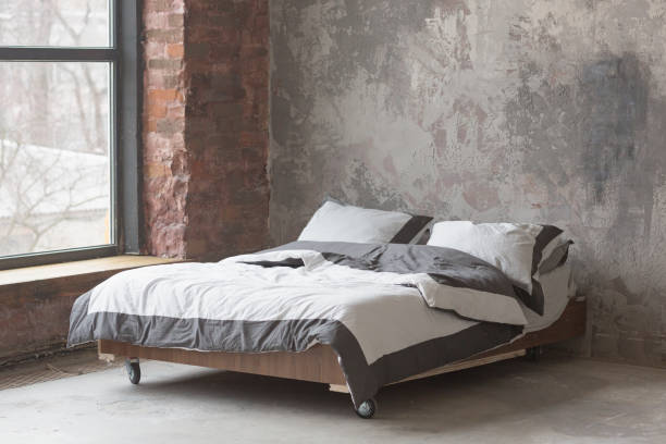 istock Loft style bedroom interior with bed, gray design, brick texture and concrete wall 1150695740
